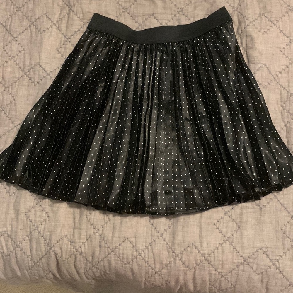 Black pleated skirt with white polka dots